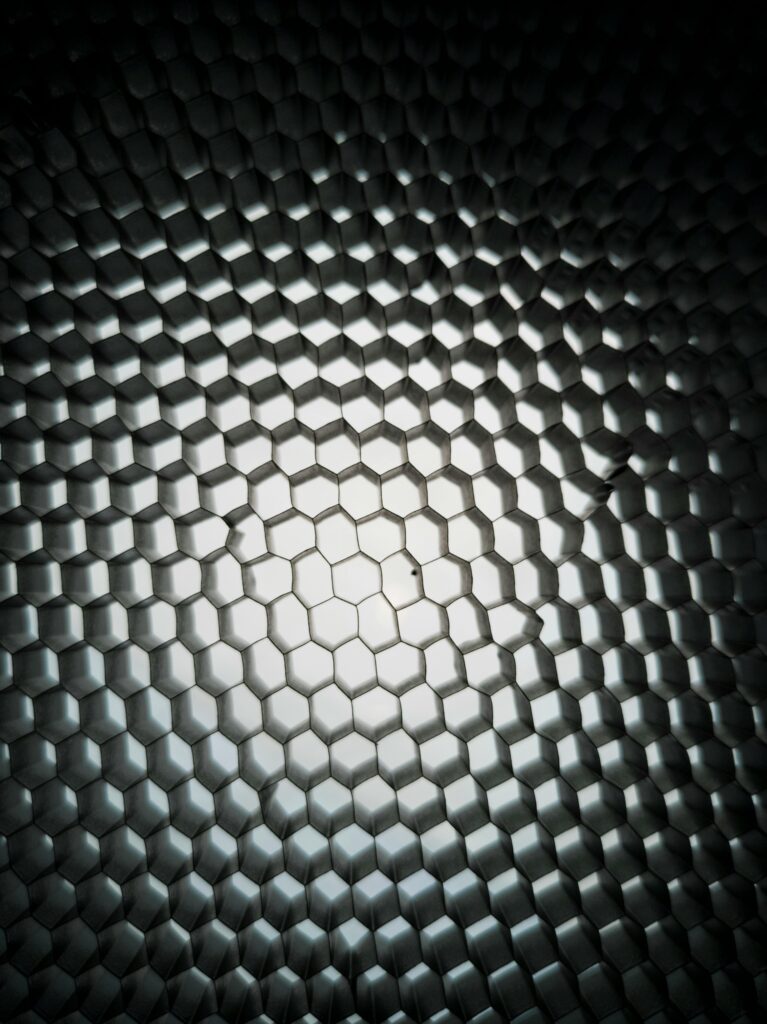 pexels-photo-2092075-2092075 Dynamic geometric honeycomb pattern with metallic texture and gradient lighting.